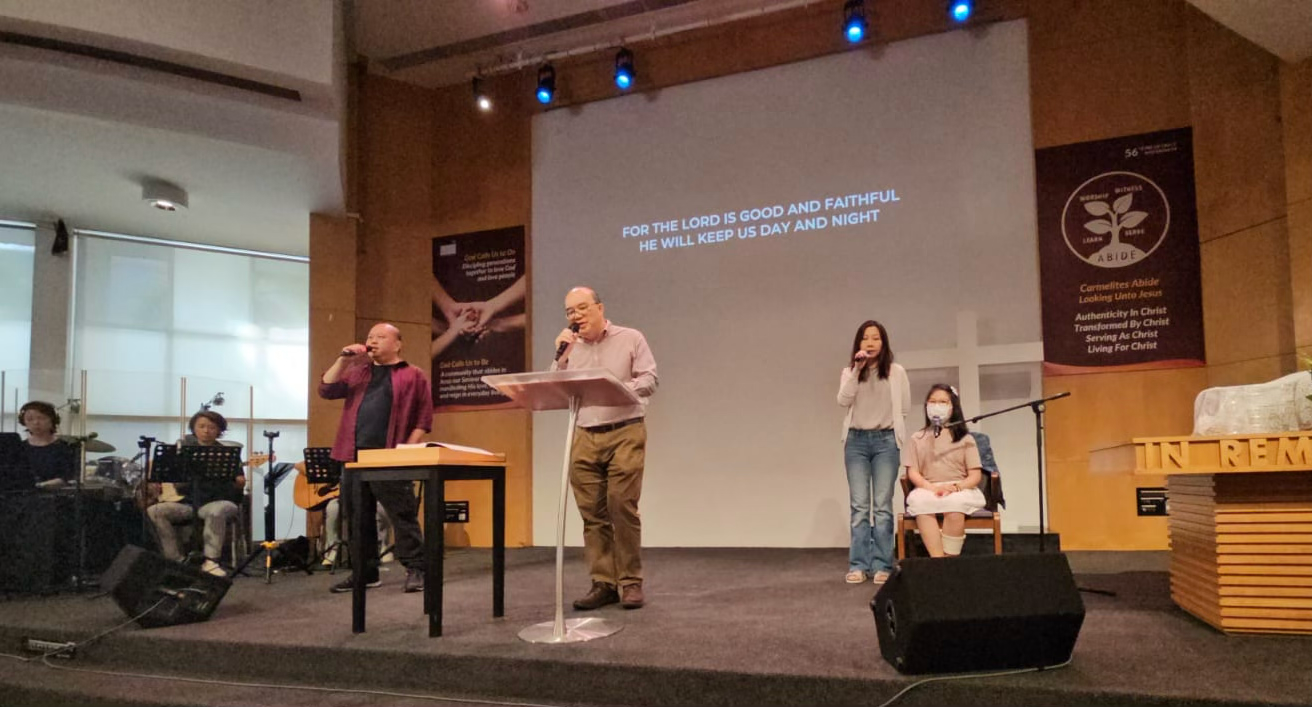 Katelyn singing at worship service with Hung Hiang and the worship team
