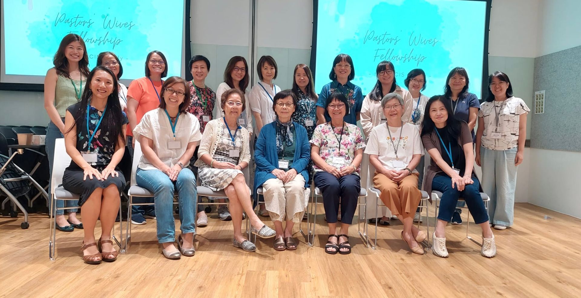 A group of women are posing for a picture in a room.