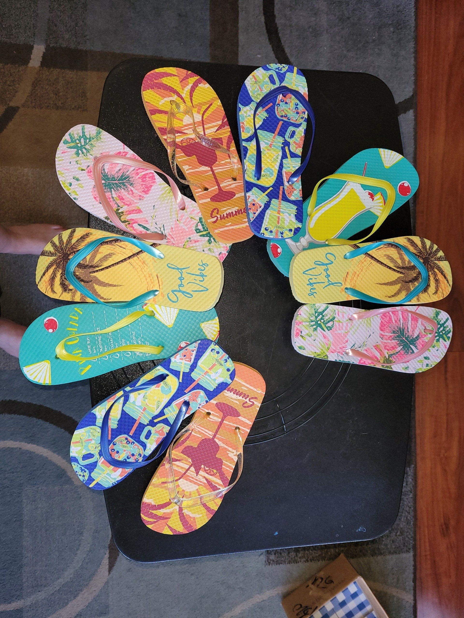 A bunch of flip flops are arranged in a circle on a table