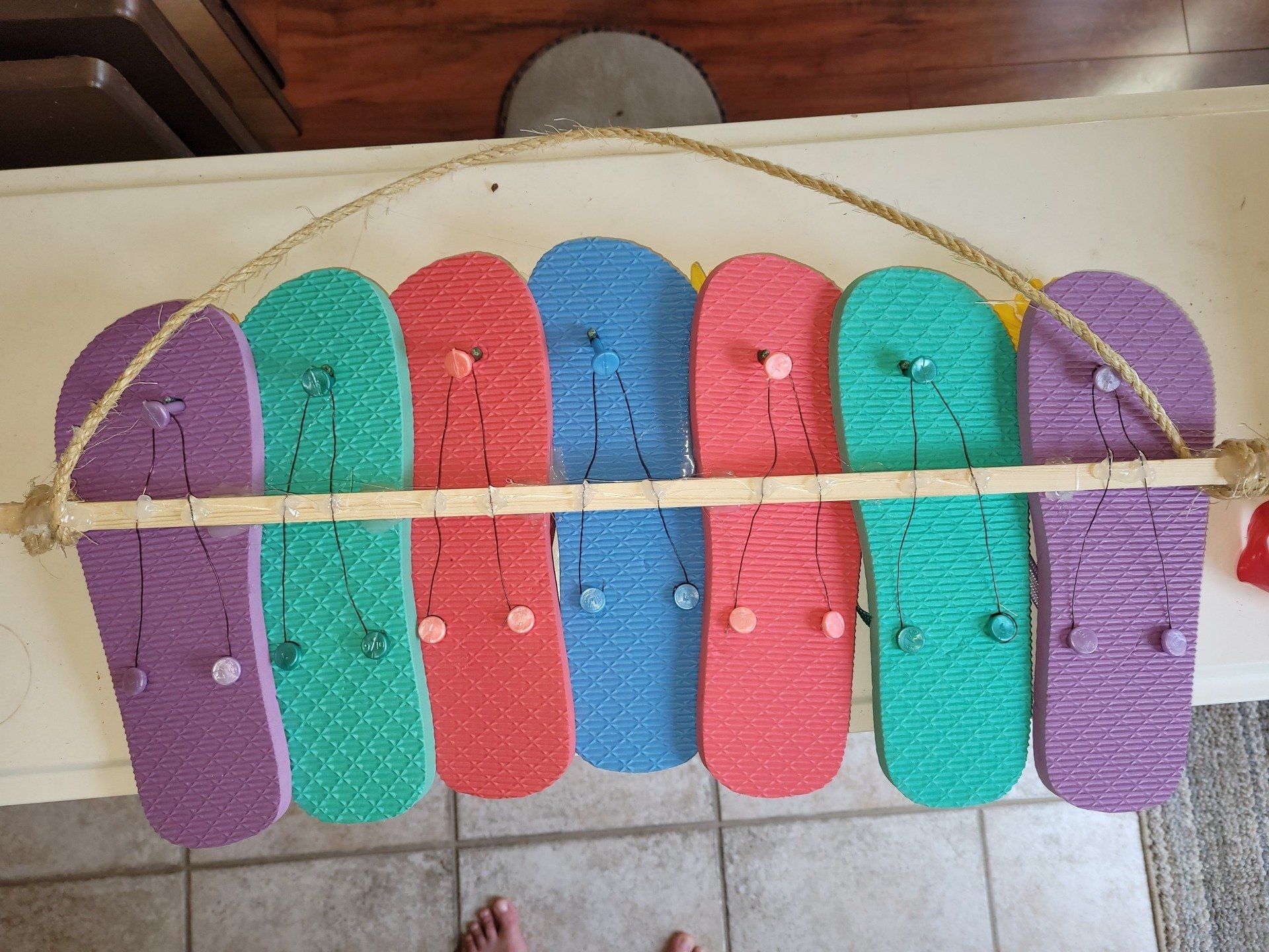 A bunch of colorful flip flops hanging on a rope