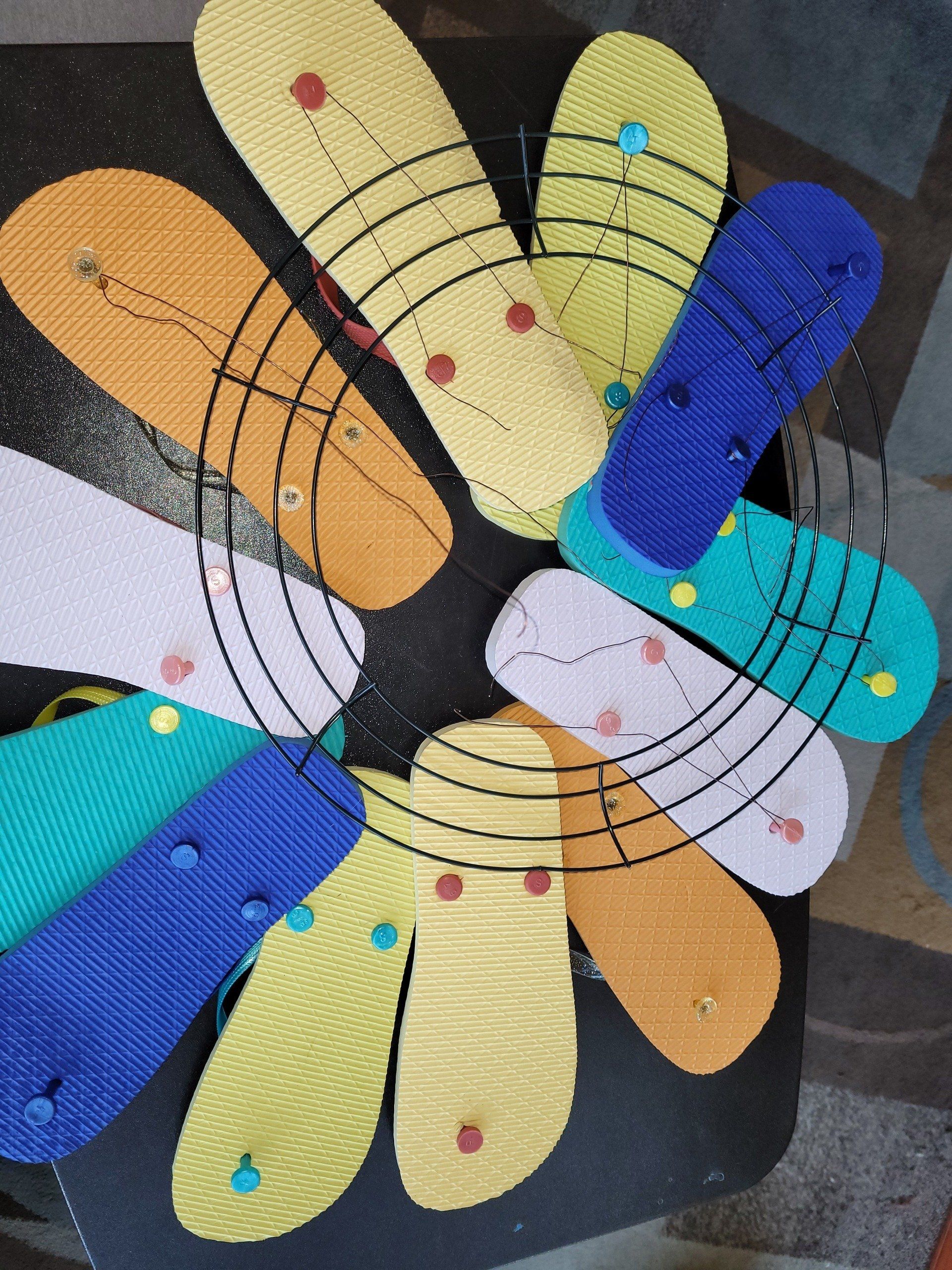 A bunch of flip flops are arranged in a circle