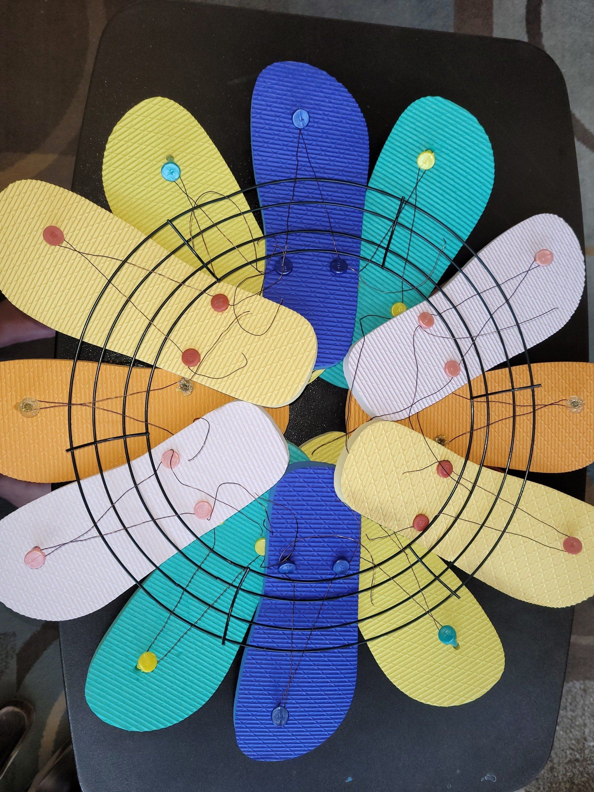 A bunch of flip flops are arranged in a circle