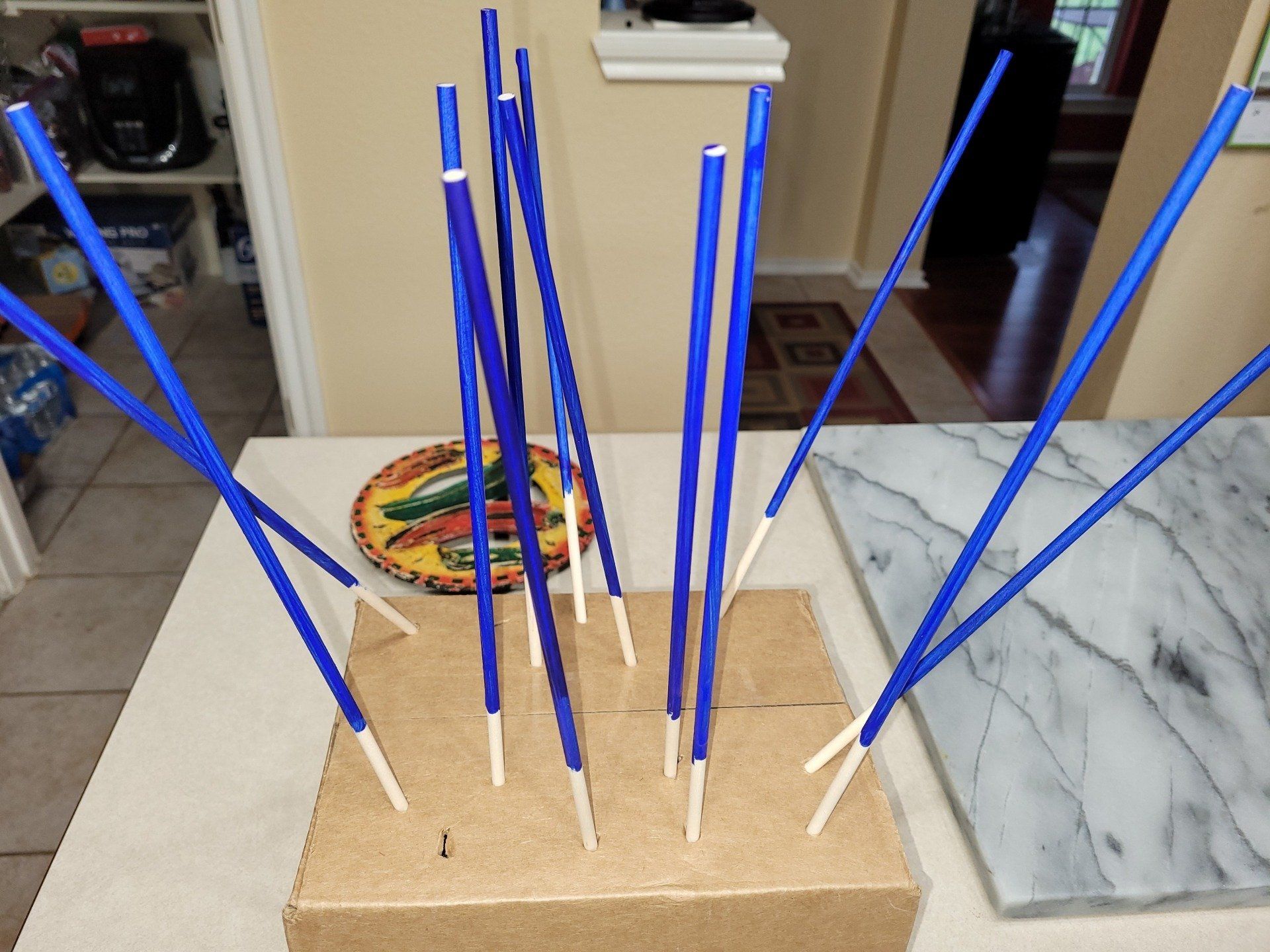A bunch of blue sticks are sitting on a table