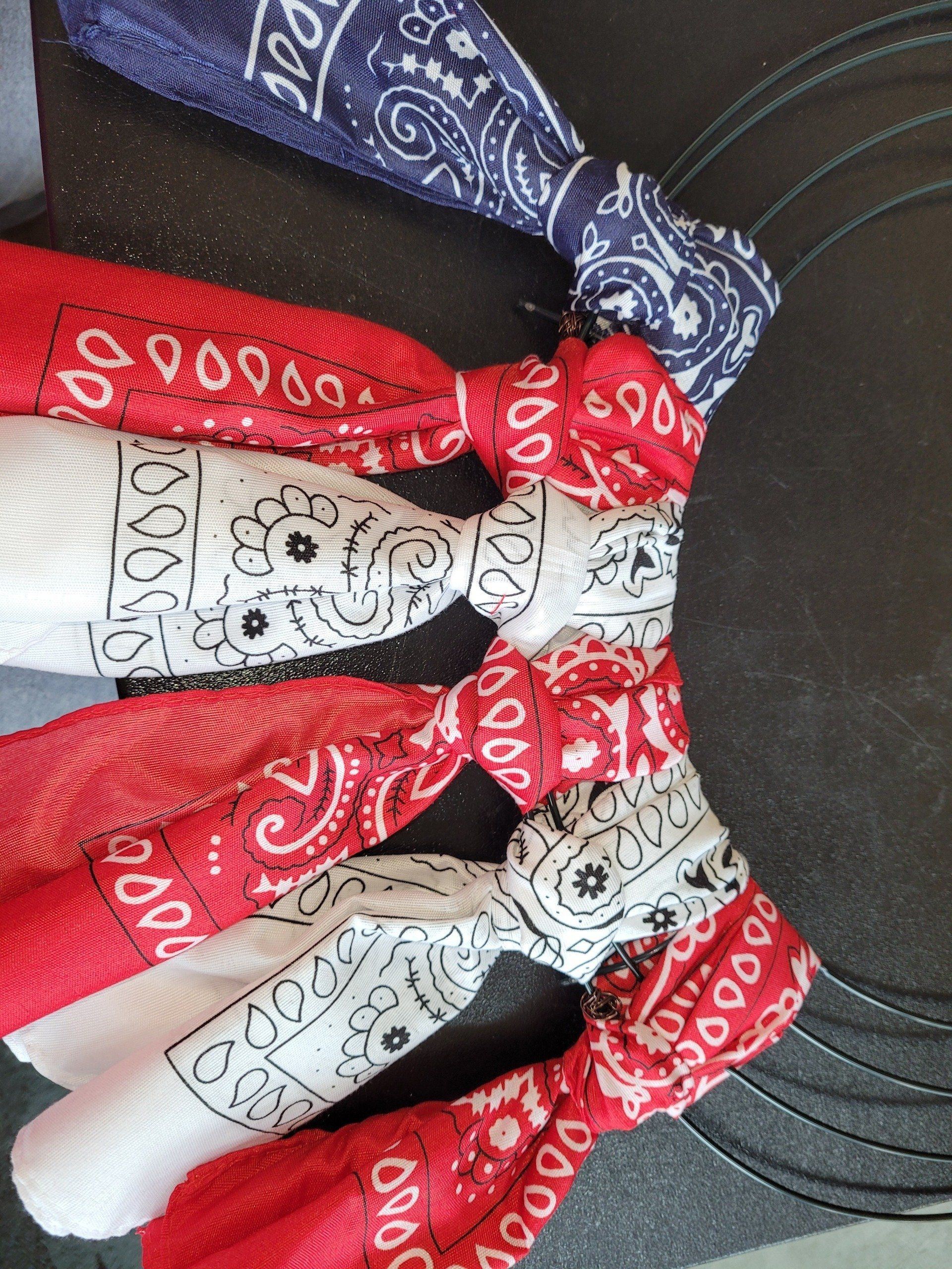 A bunch of bandanas tied together on a black surface