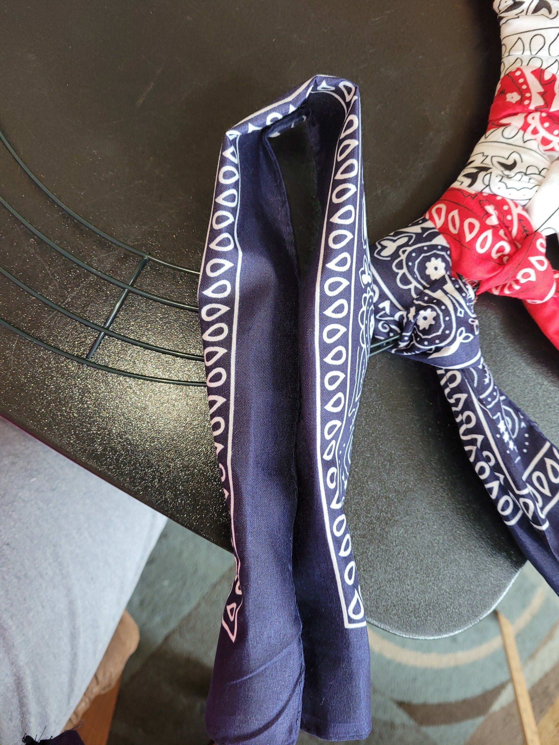A blue and white bandana is laying on a table
