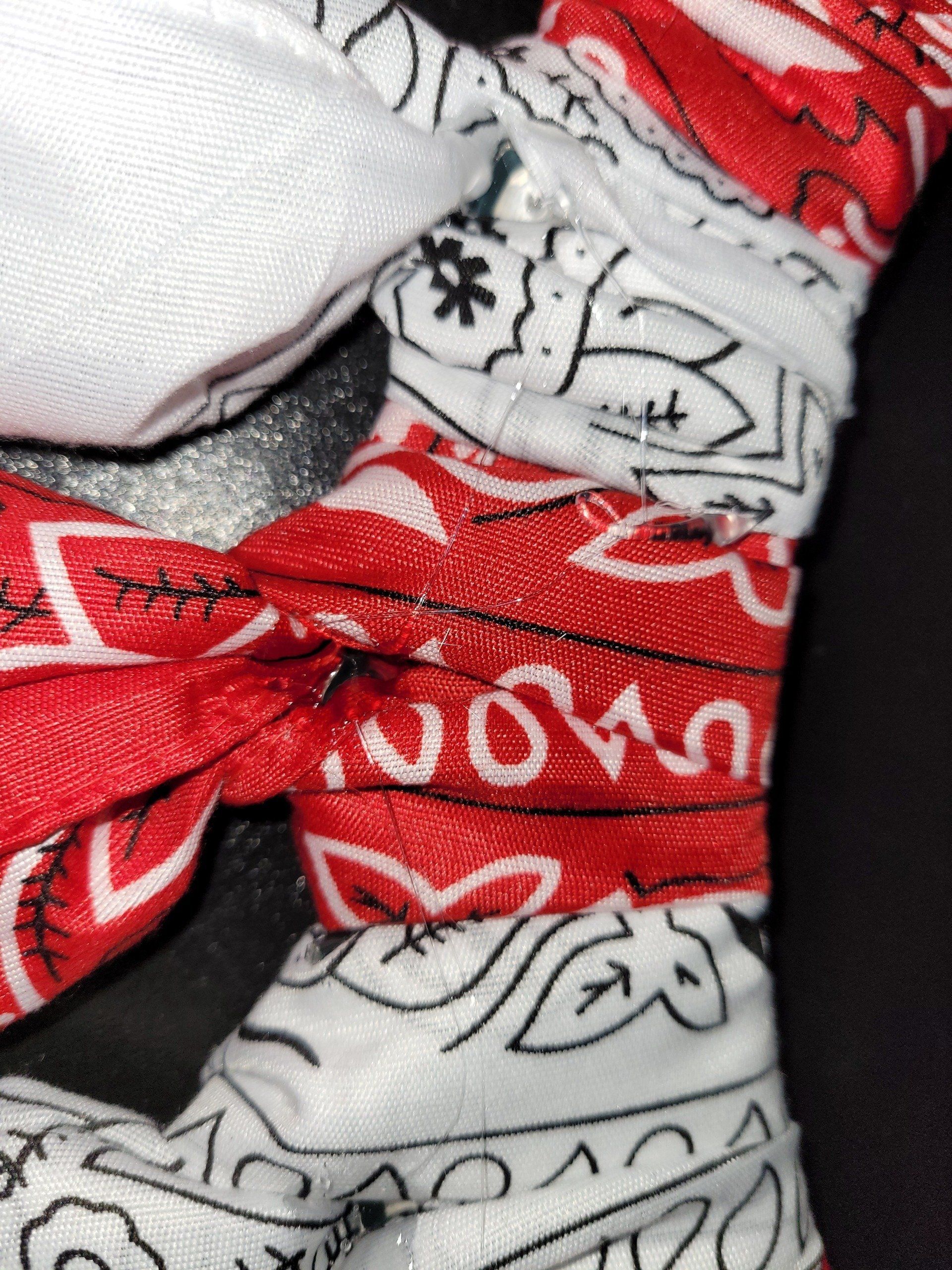 A close up of a red and white bandana on a black surface