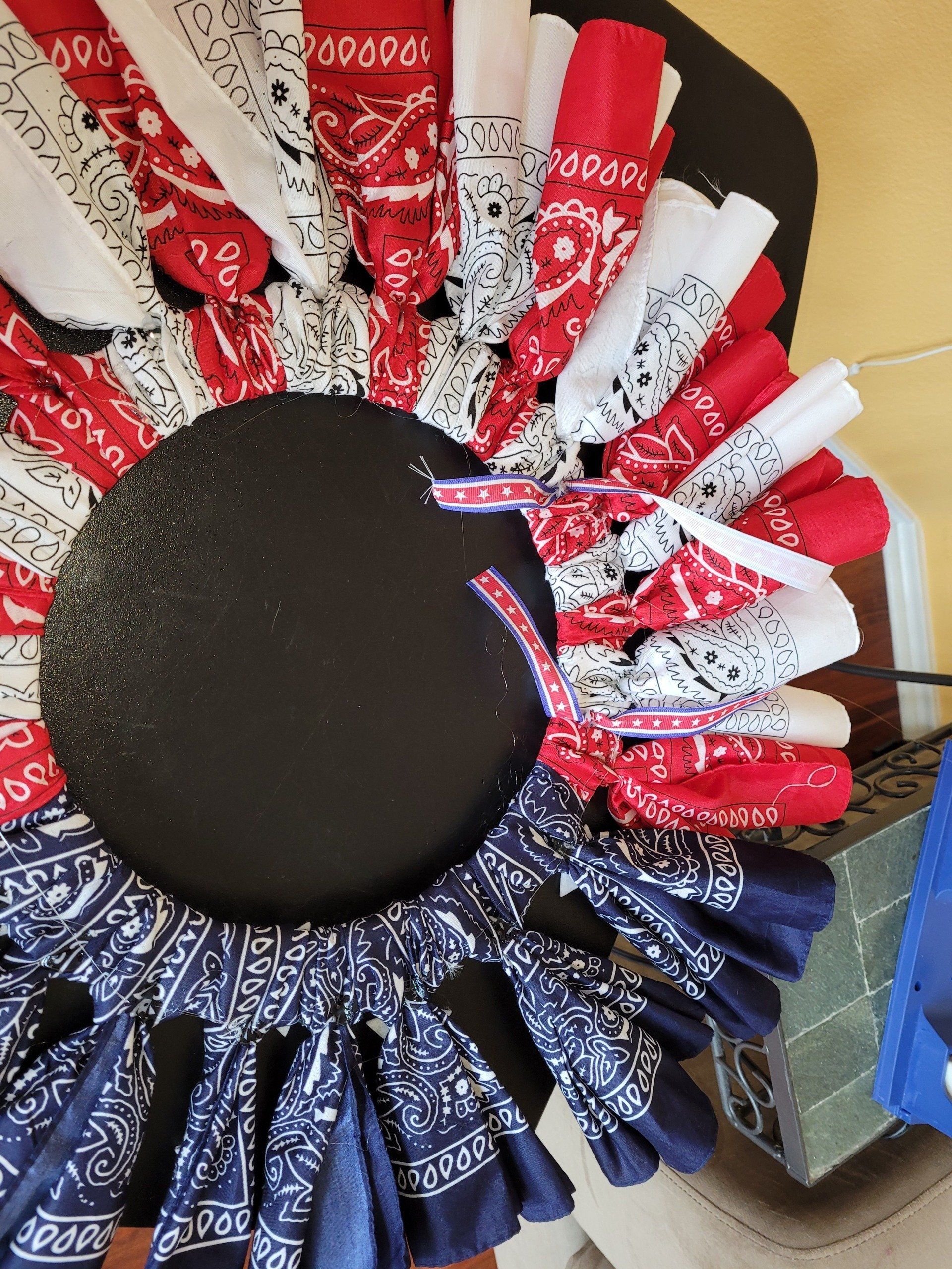 A red white and blue bandana wreath with a black center