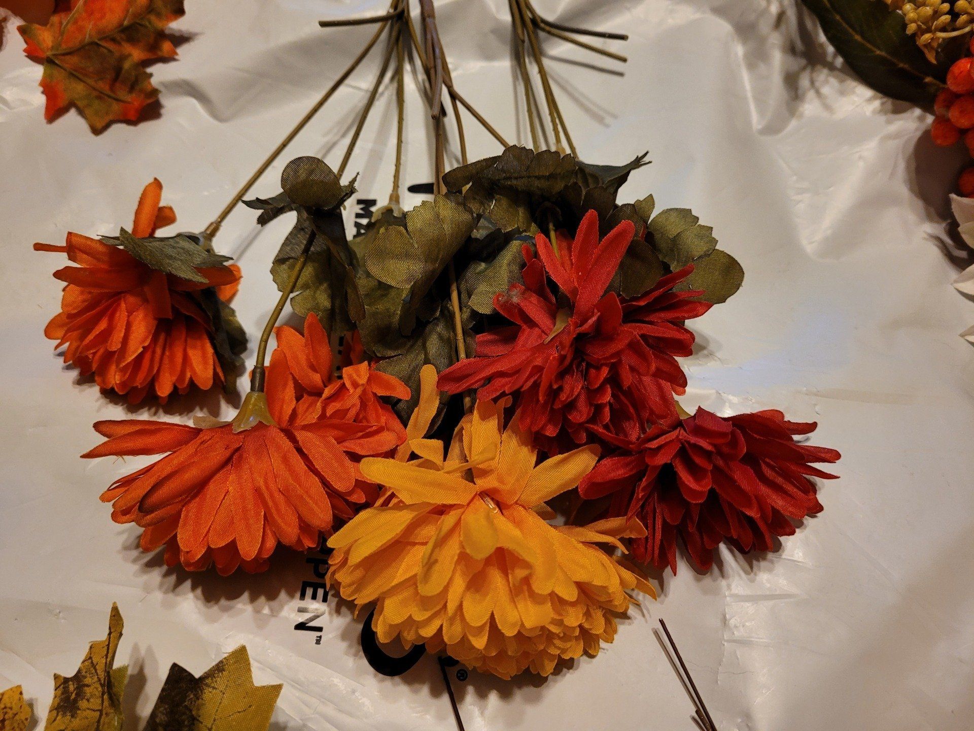 A bunch of orange and yellow flowers on a table