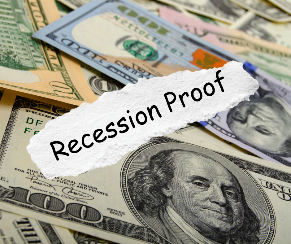 A pile of money with a piece of paper that says recession proof