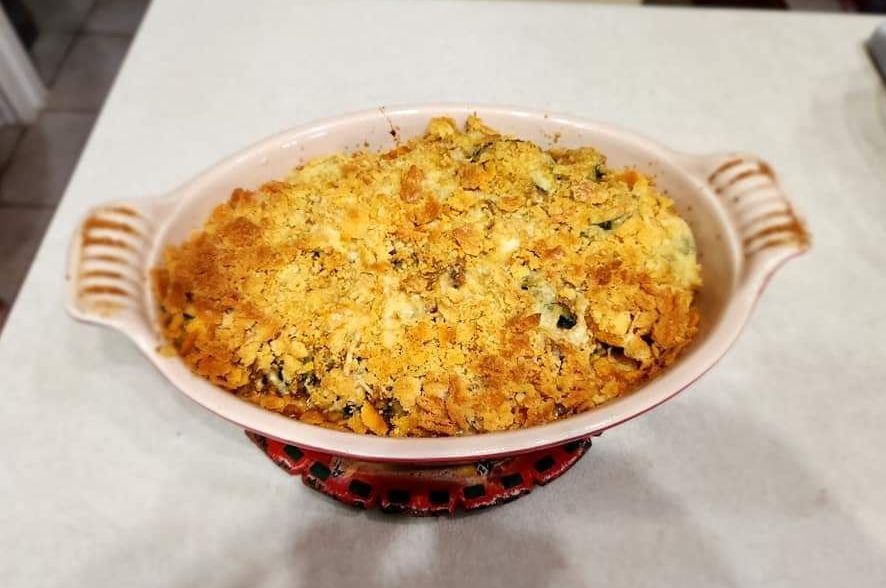A casserole dish filled with food is sitting on a table.