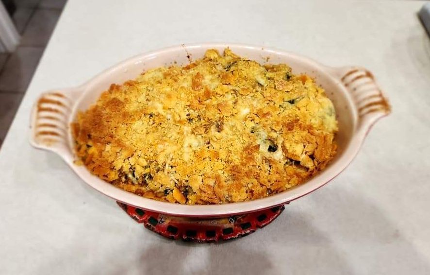 A casserole dish filled with food is sitting on a table.