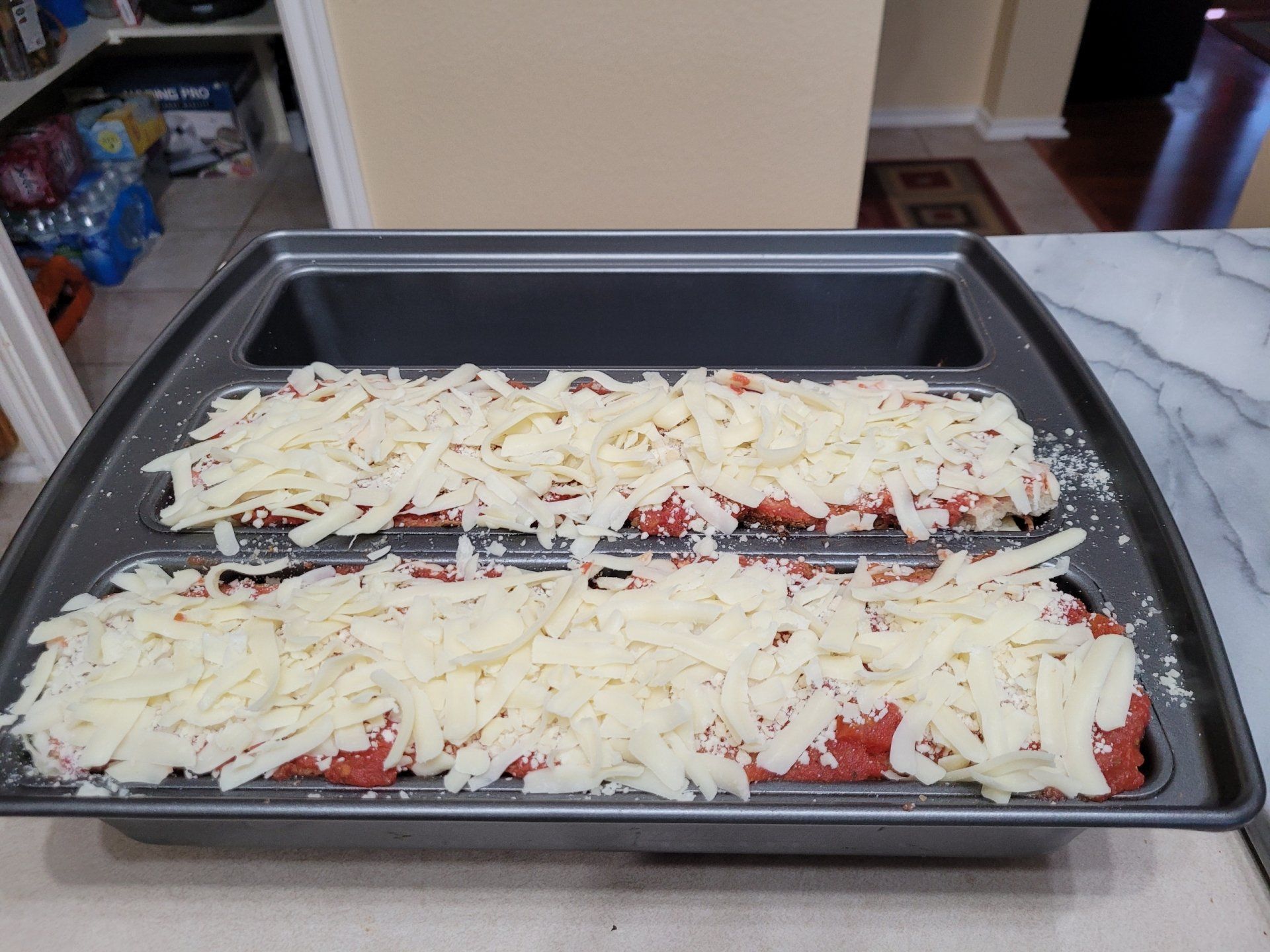 A pan filled with meat and cheese is sitting on a counter.