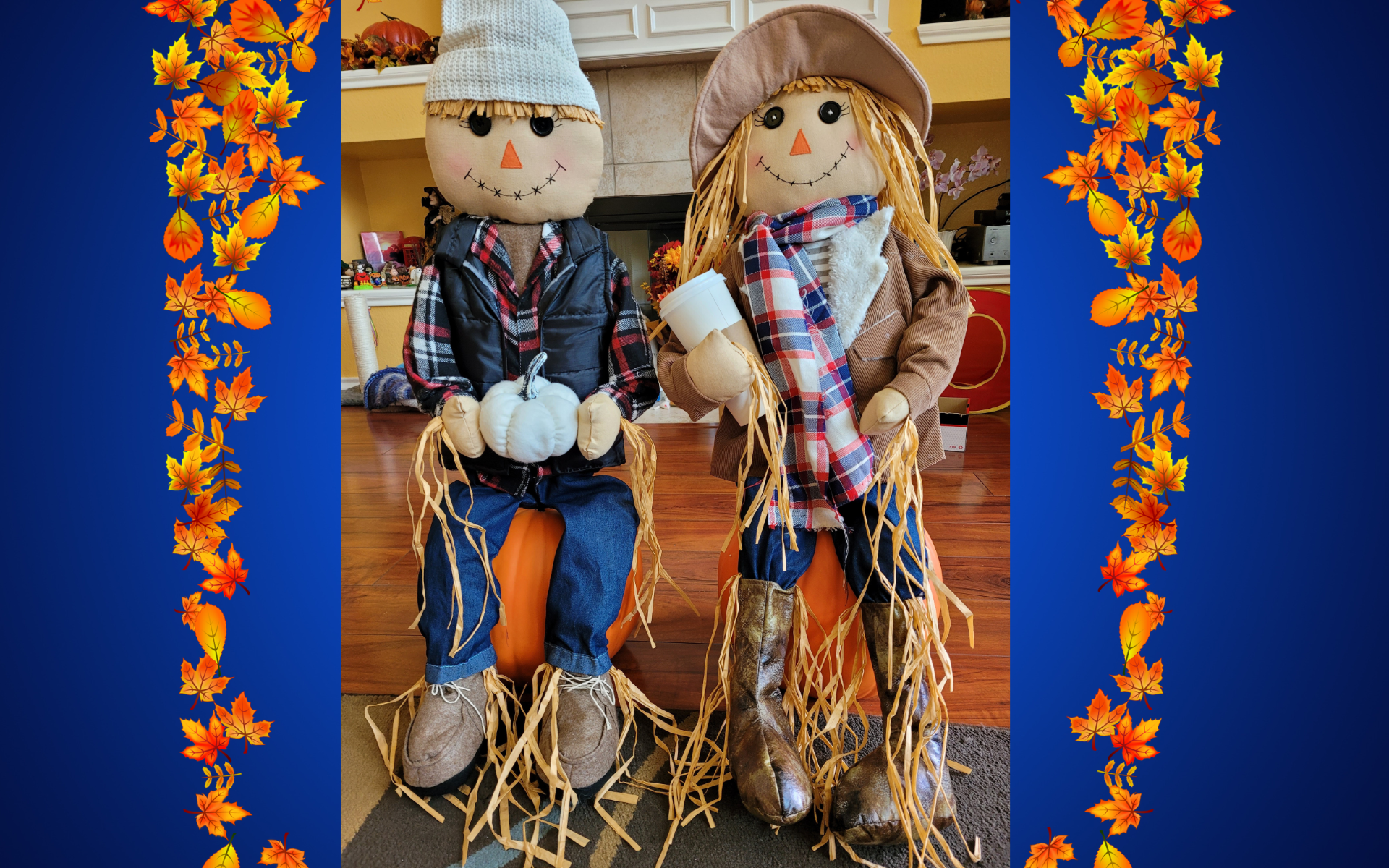 A boy and a girl scarecrow are sitting on a pumpkin.