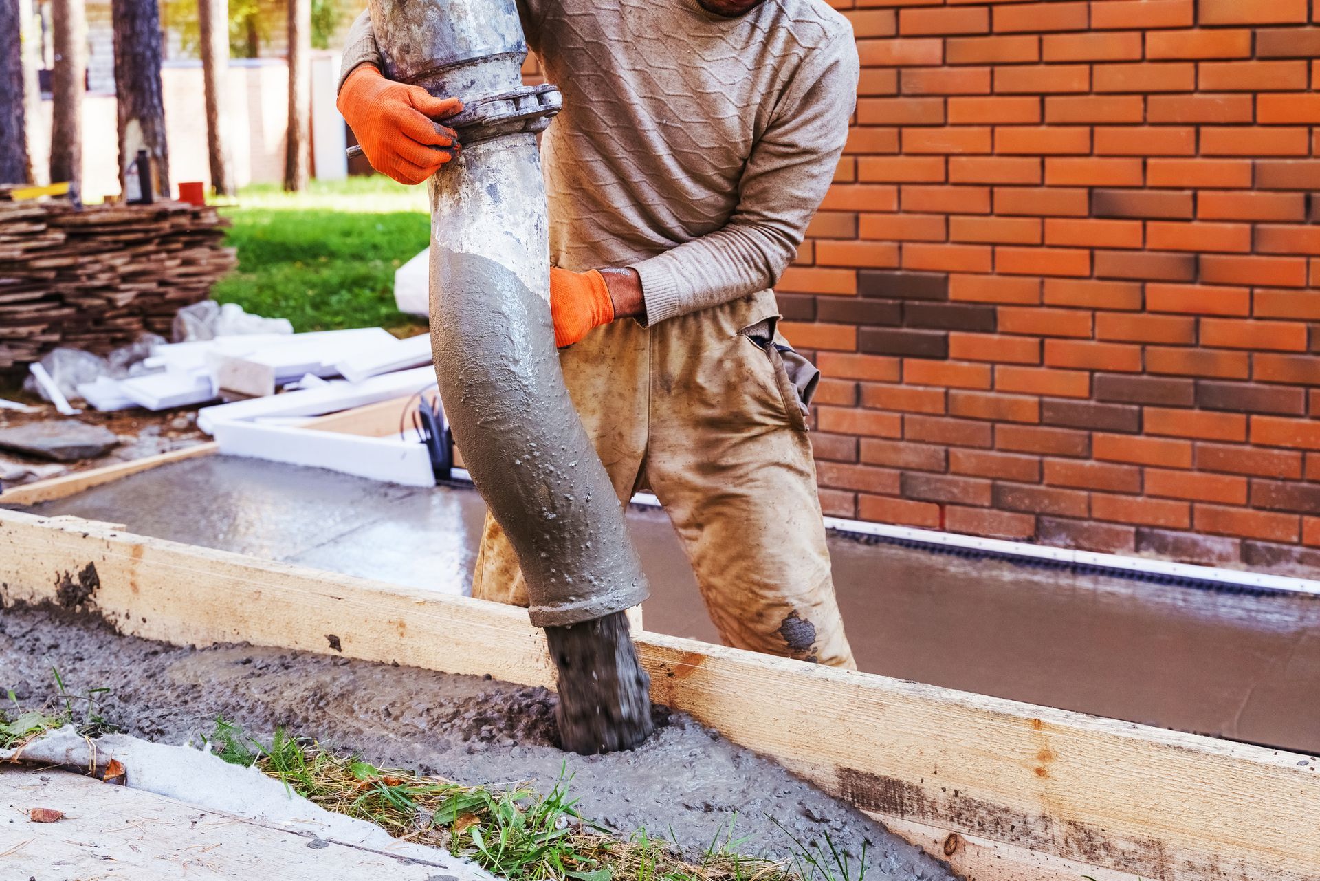 A concrete mixing contractor providing service by pouring cement on-site for building construction.