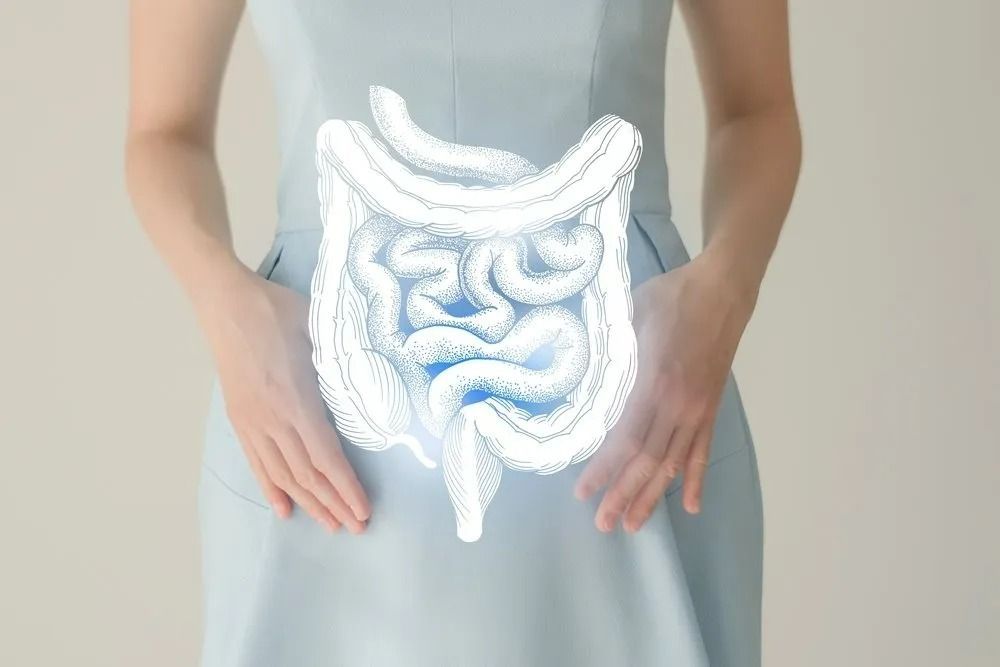 Woman in A Blue Dress with An Illustration of The Digestive System Superimposed Over Her Torso — The Colonic Coach in Gulliver, QLD