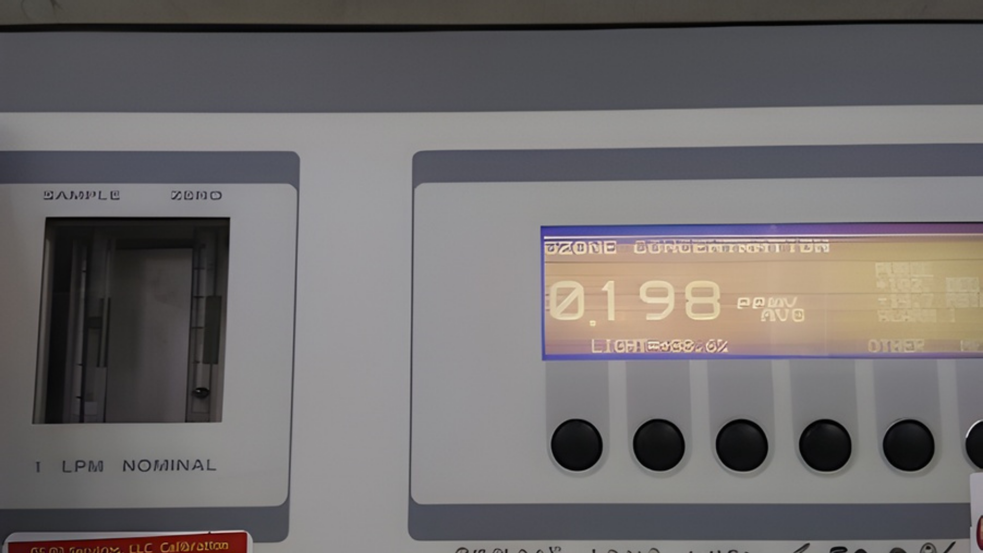 Digital industrial control panel with a backlit display showing 