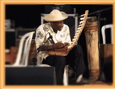 A man in a hat is playing a musical instrument