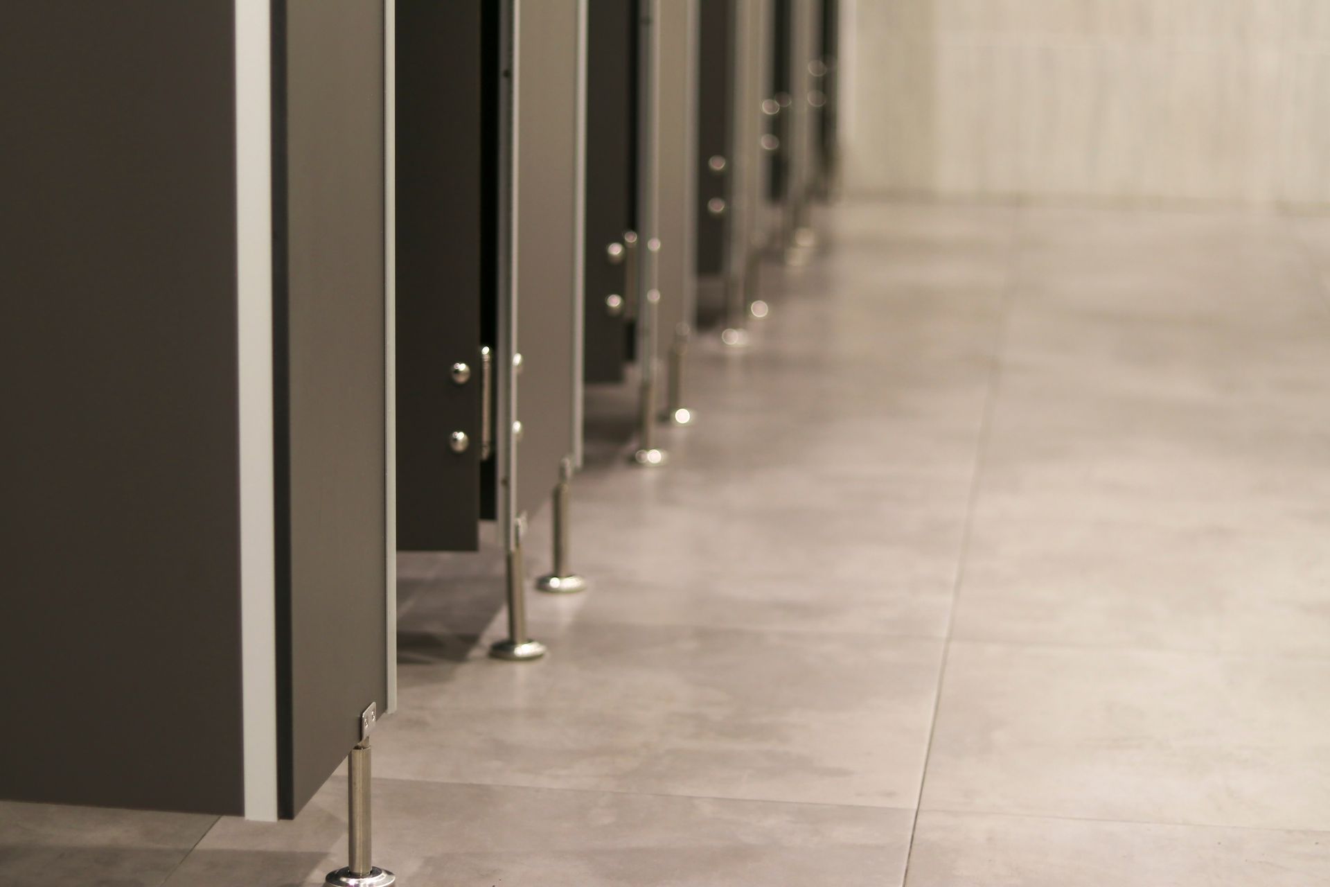 A row of toilet cubicles in a public restroom.