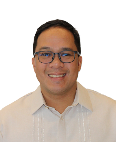 A smiling person with dark hair and glasses, wearing a light-colored barong shirt against a white background.
