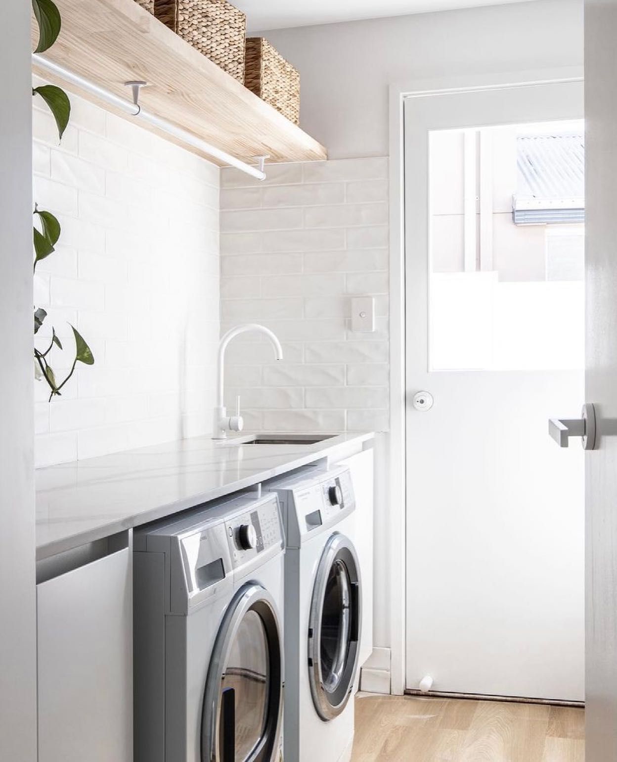 A Laundry Room With Two Washing Machines and a Sink — Hot Rock Granite In Burleigh Heads, QLD