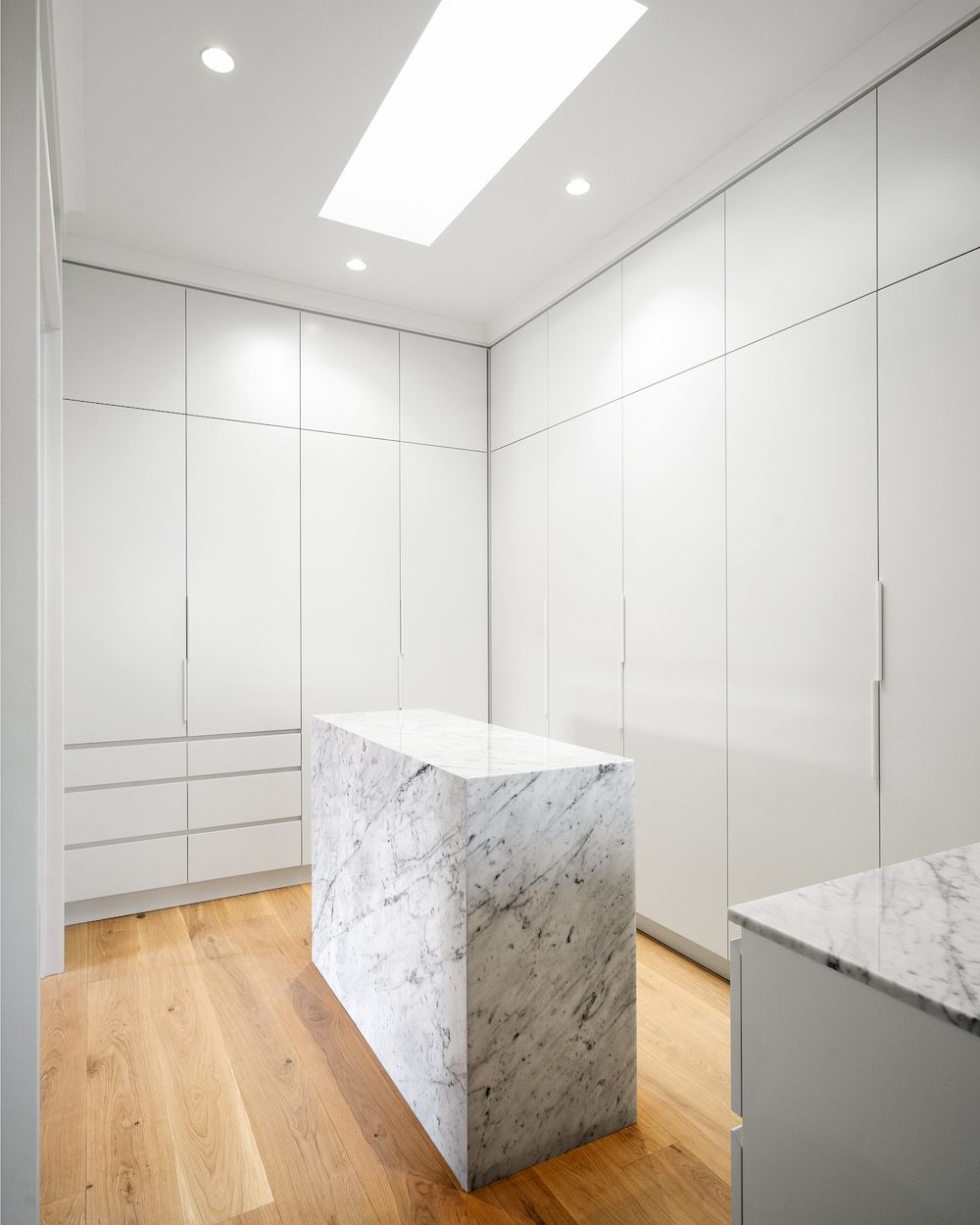 A Walk in Closet With a Marble Island in the Middle — Hot Rock Granite In Tweed Heads, NSW