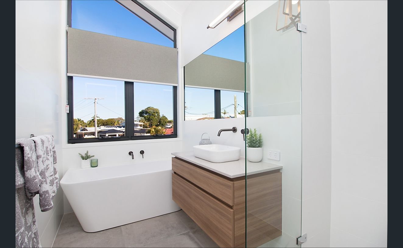 A Bathroom With a Tub, Sink, Mirror and Window — Hot Rock Granite In Burleigh Heads, QLD