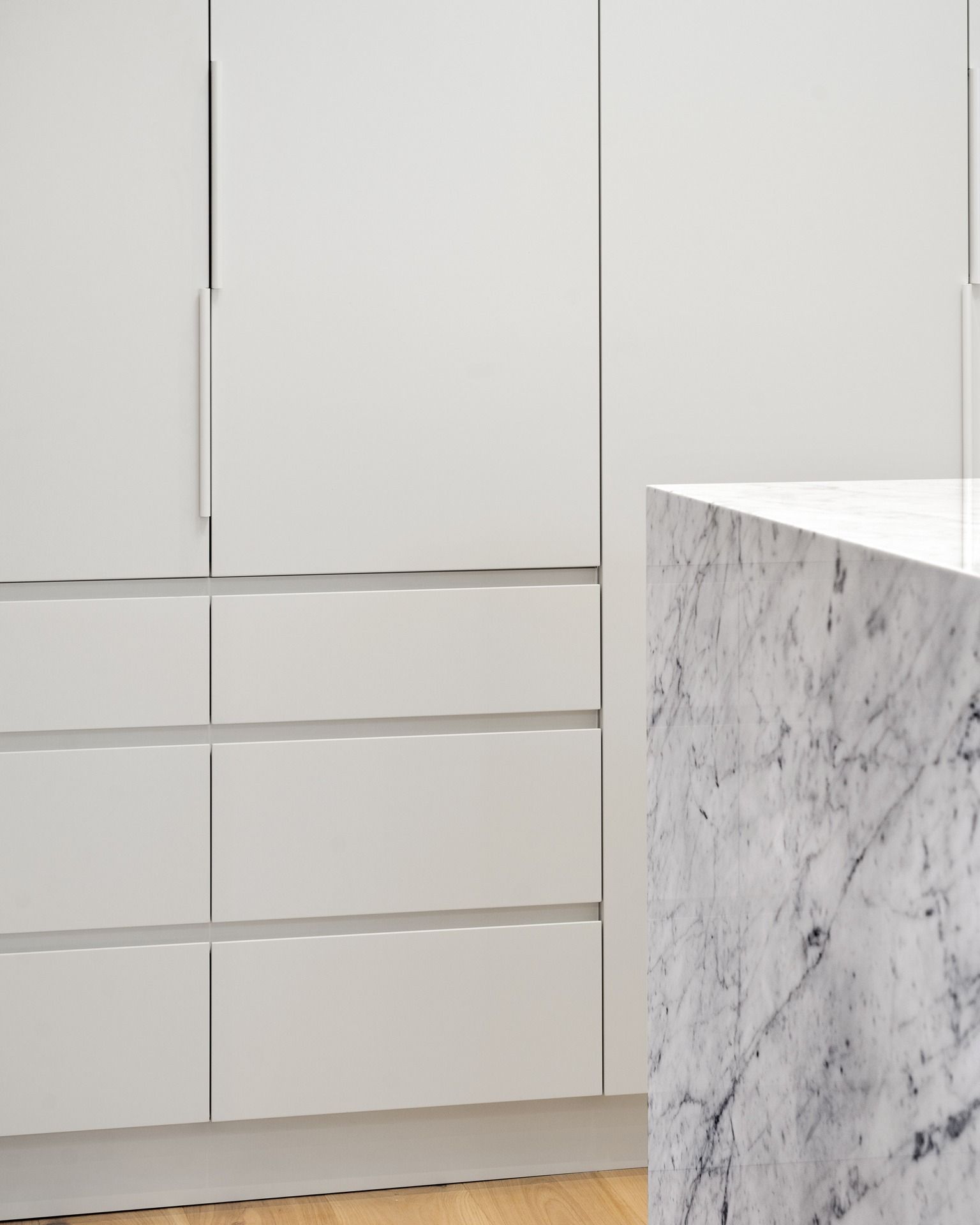 A Kitchen With White Cabinets and a Marble Counter Top — Hot Rock Granite In Byron Bay, NSW