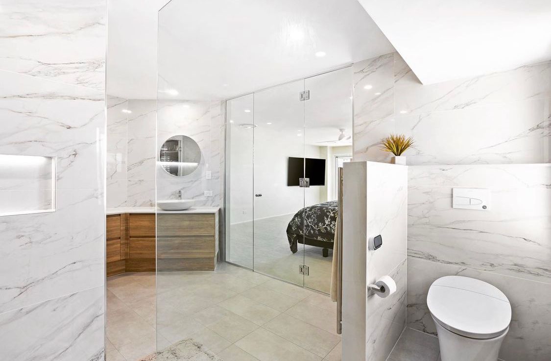 A Bathroom With a Toilet, Sink, Mirror and Walk in Shower — Hot Rock Granite In Burleigh Heads, QLD