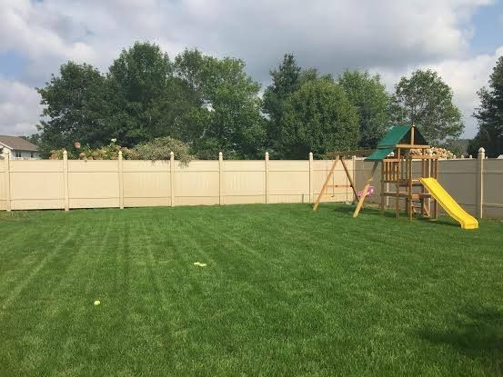 wood fence with playground in backyard