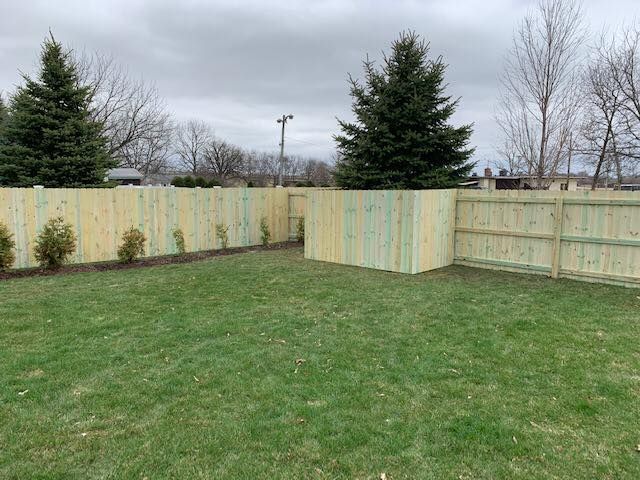 custom made wood fence in backyard