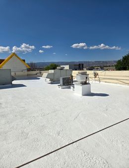 A white roof with a yellow roof in the background