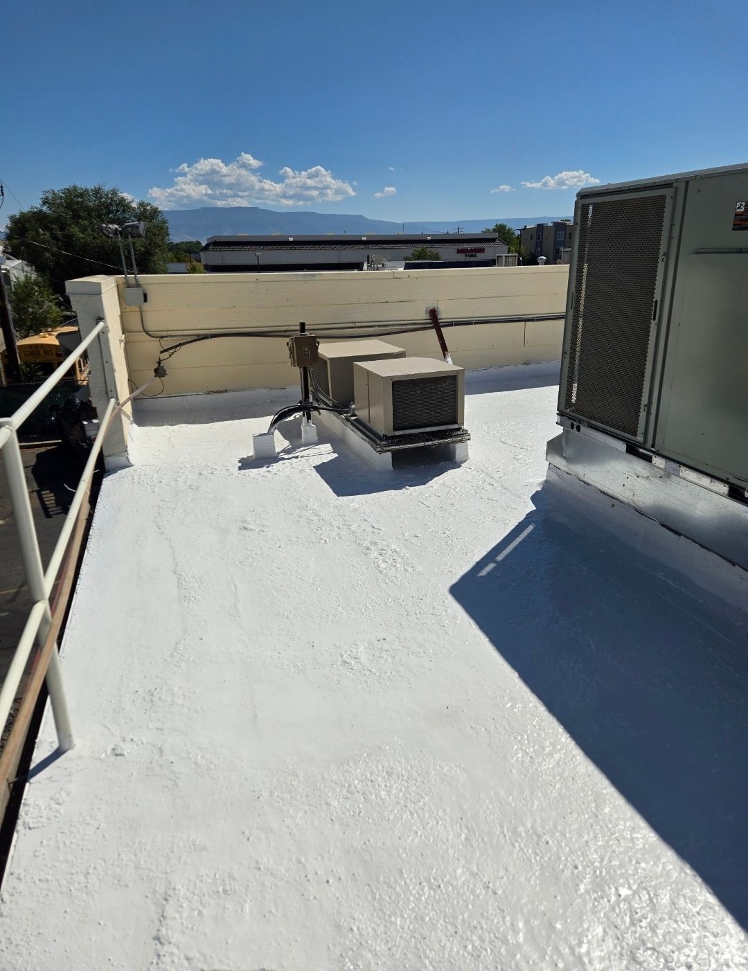 A roof with a lot of air conditioners on it.