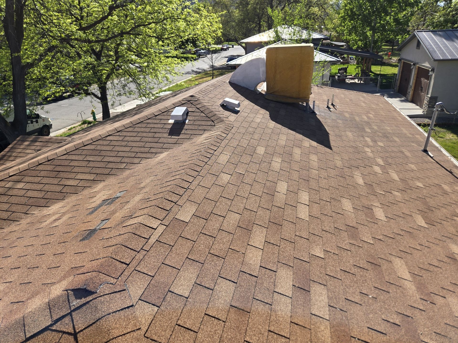 A brown roof with a chimney on top of it.