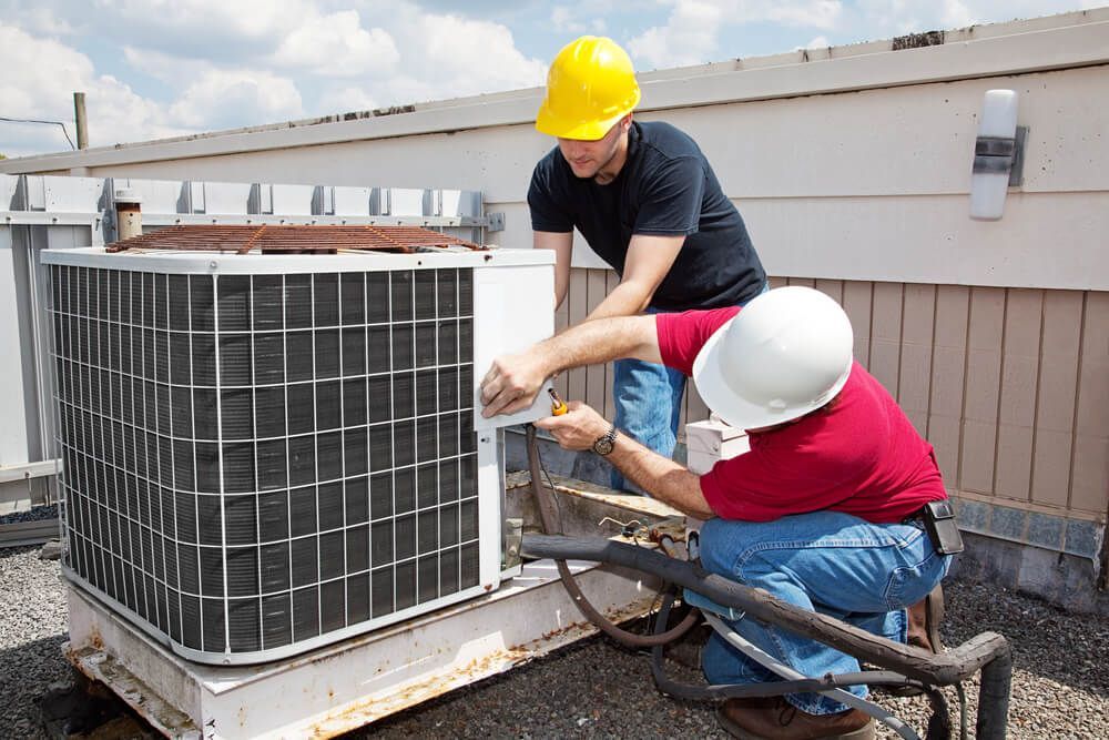 Electricians Fixing Outdoor Unit — HVAC Systems in Parkes, NSW