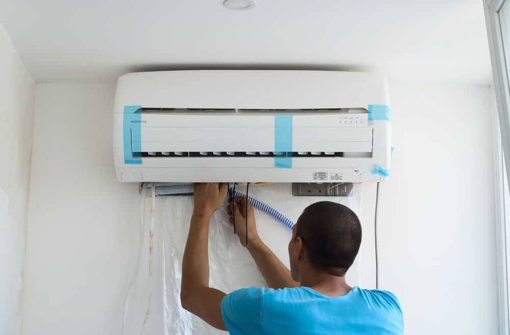 Man Installs Indoor Unit — HVAC Systems in Orange, NSW