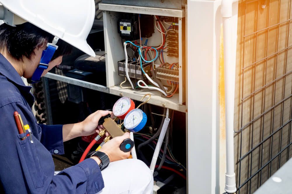 Technician Checking Air Conditioner Pressure — HVAC Systems in Dubbo, NSW