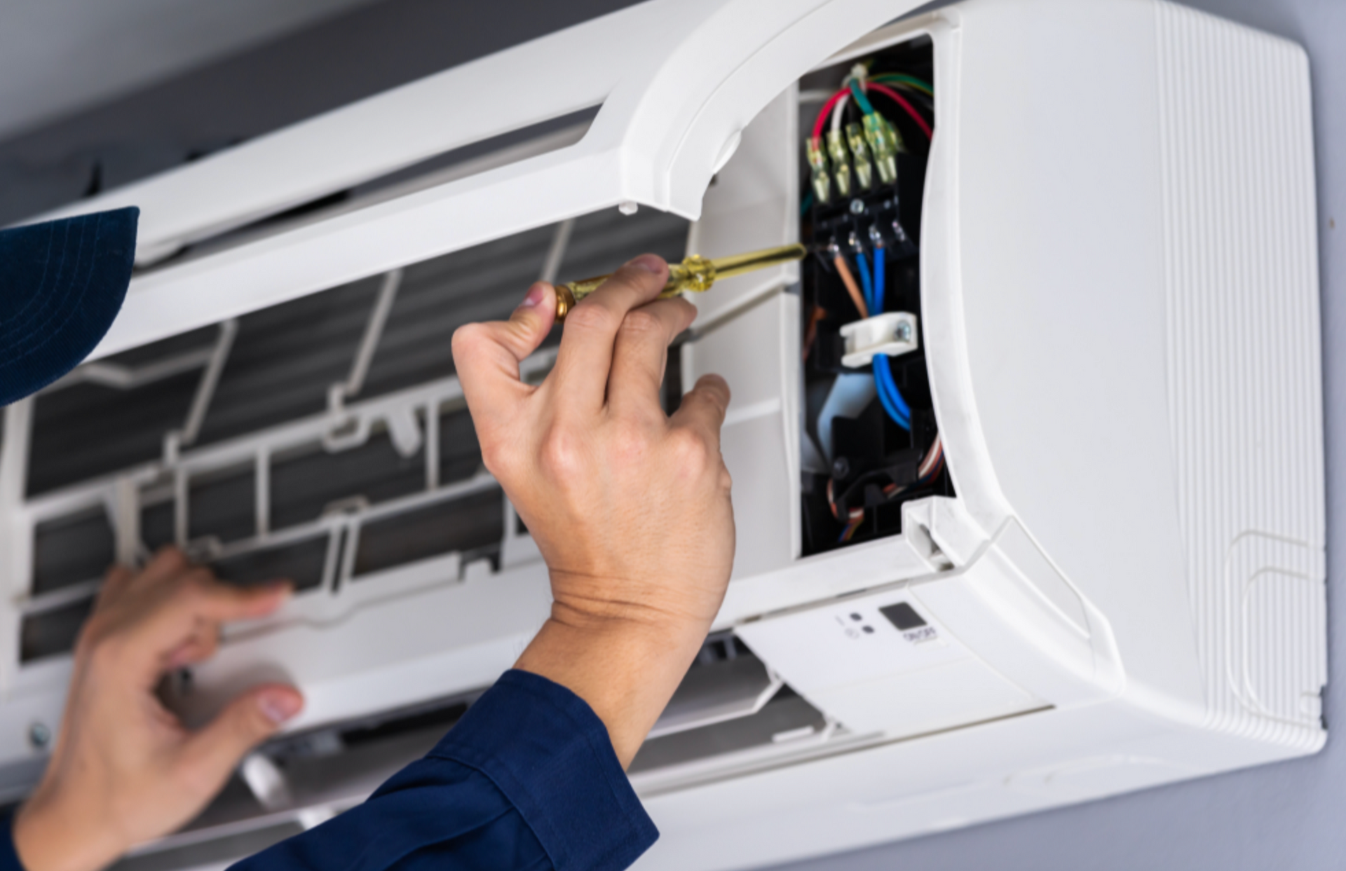 Technician fixing an air conditioner