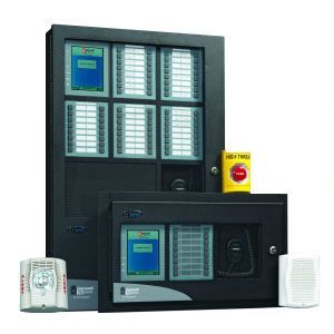 Commercial alarm control panels with keypad displays and red emergency stop button on a dark cabinet