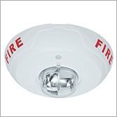 White wall-mounted alarm with yellow center beacon and red “ALERT” text on both sides