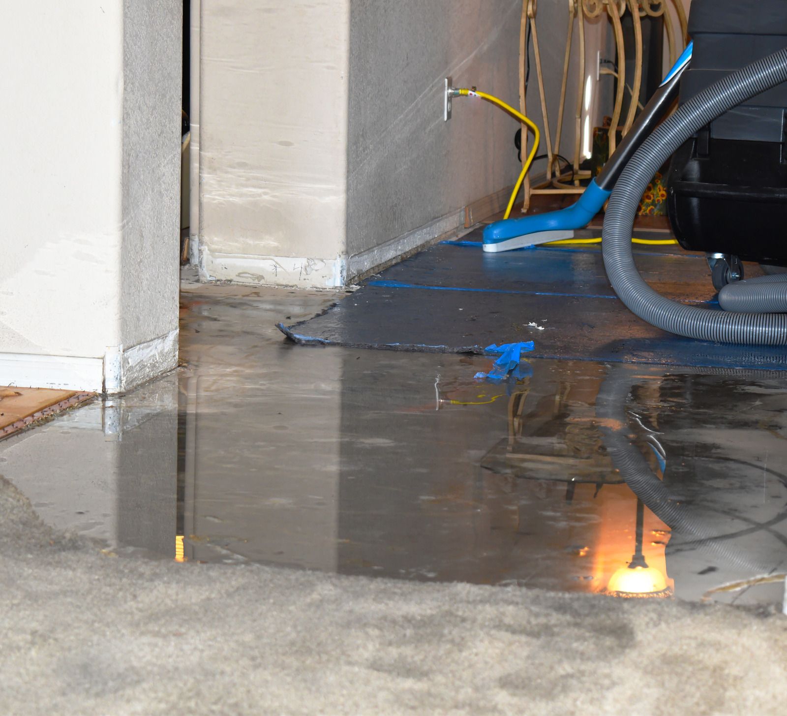 Wet concrete pouring from a truck chute onto a construction site, forming a gravelly slab surface