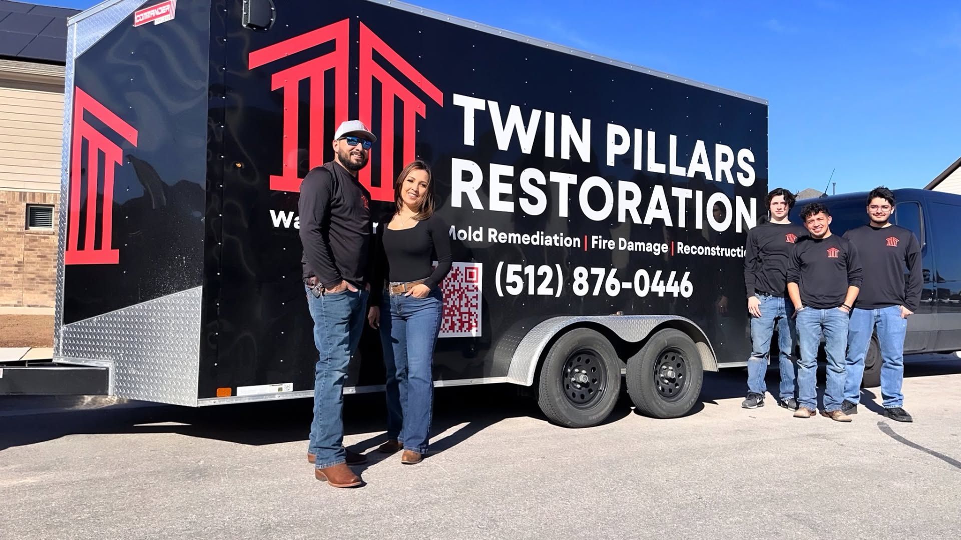 Twin Pillars Restoration truck with team standing outside on a sunny day
