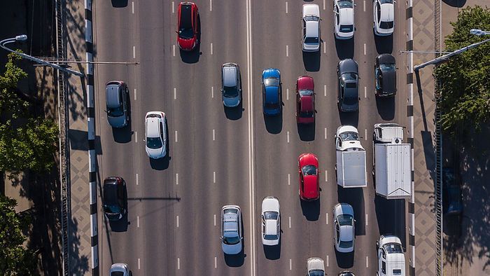 An aerial view of a busy highway filled with cars and trucks.