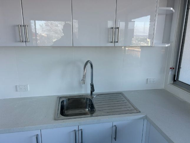 White Kitchen With Stainless Steel Sink — Fry Electrical In Budgewoi, NSW