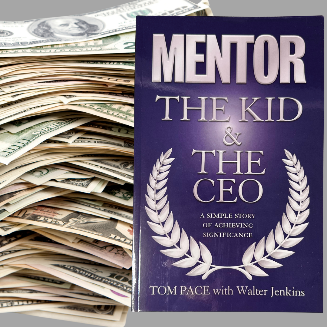 A stack of money next to a mentor the kid and the ceo book
