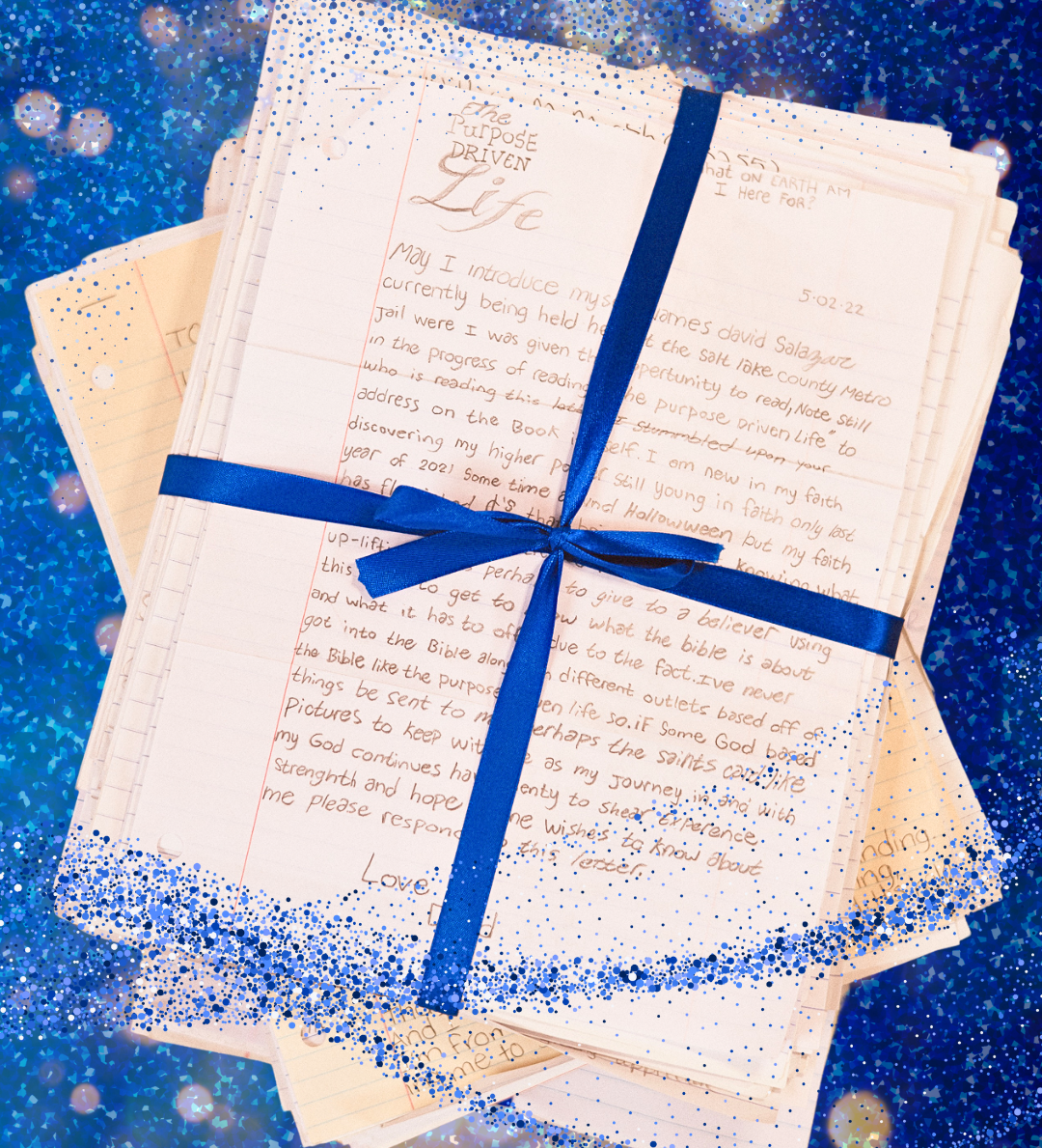 A stack of letters tied with a blue ribbon