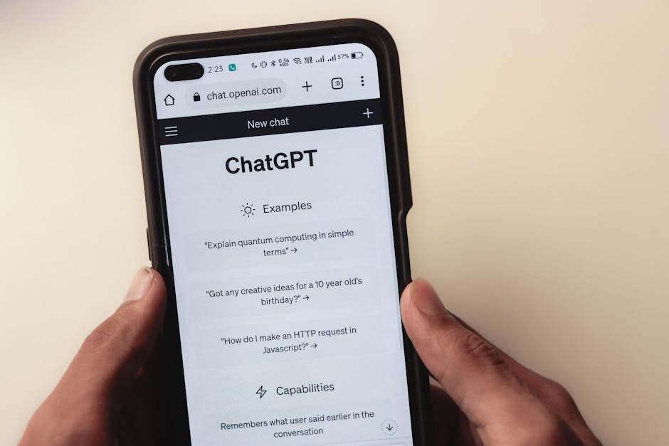 Person holding a phone displaying the ChatGPT interface. The background is plain.