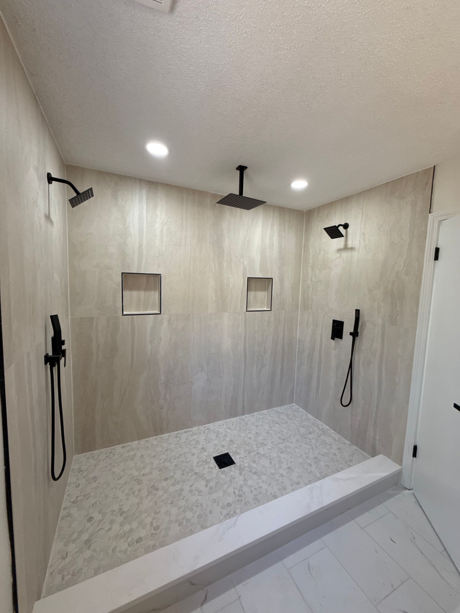 Bathroom remodel with three heads and new tile backsplash