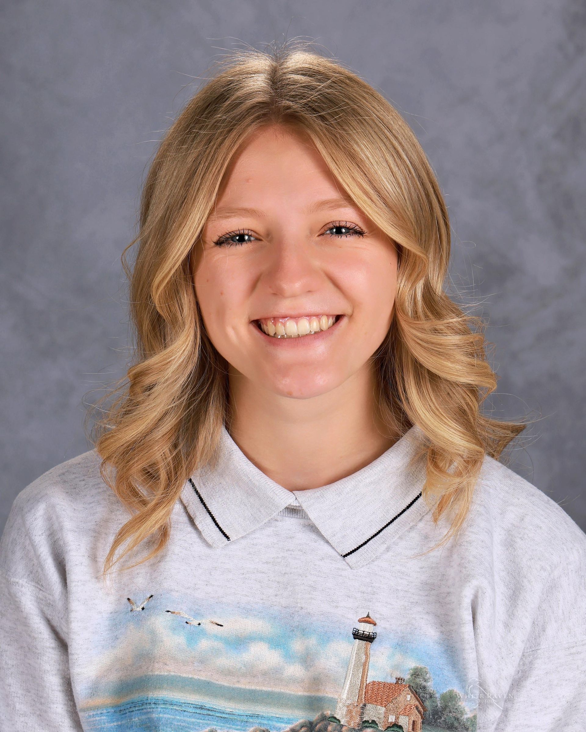Woman in white shirt  smiling for camera
