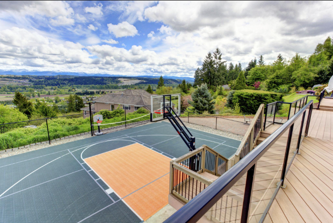 Custom backyard basketball court overlooking a scenic landscape and outdoor deck during a court installation service in Peoria, AZ