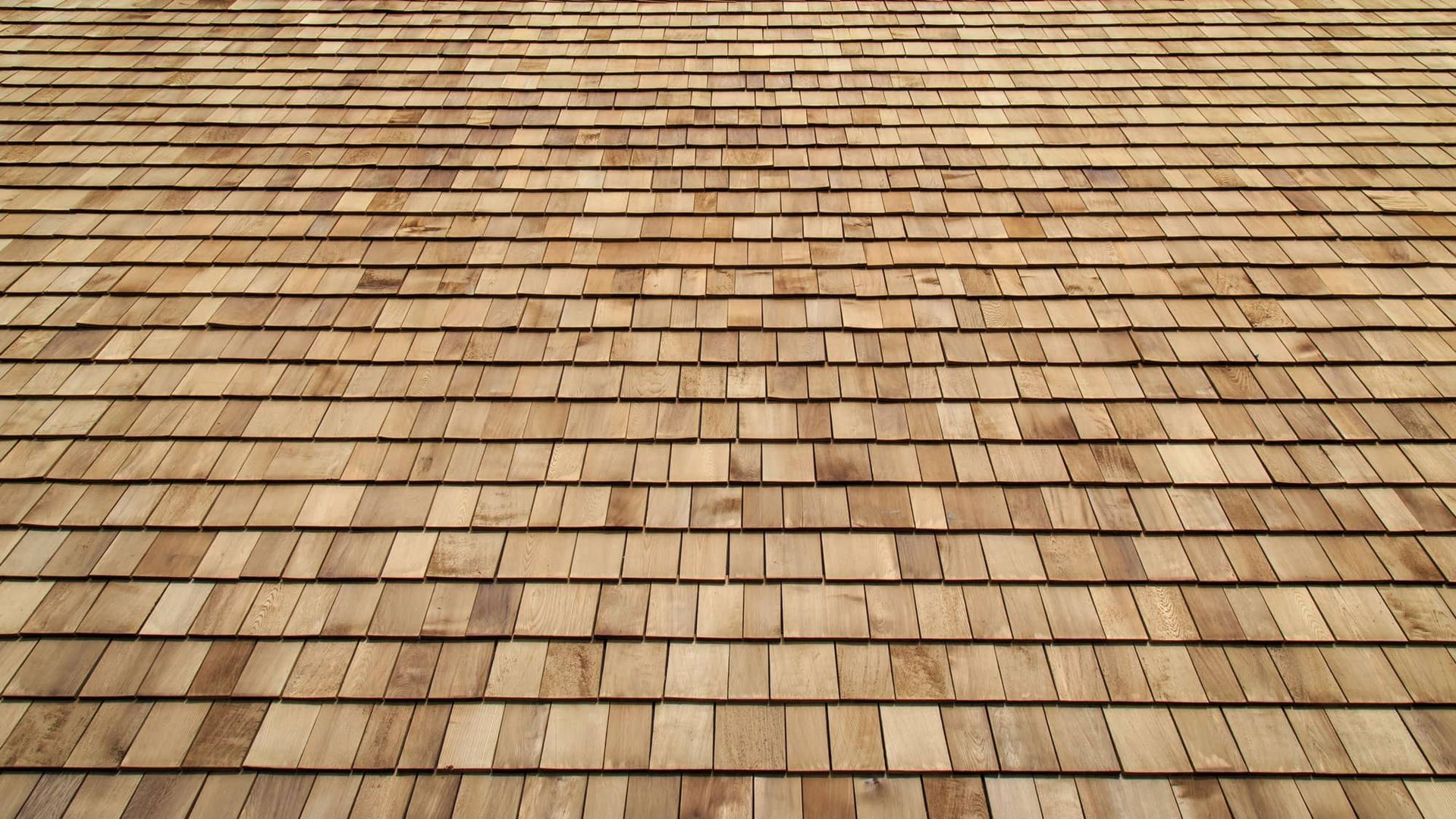 Rows of weathered wooden shingles forming a textured rooftop pattern